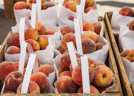 Bags of peaches at a local farmers market for saleの写真素材