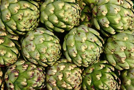 Fresh, whole, green artichokes at a local farmers marketの写真素材