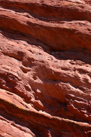 Red stone wall showing centuries of erosion