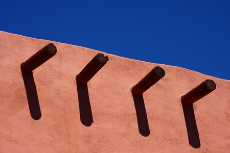 An wall with roof timbers under clear blue skyの写真素材