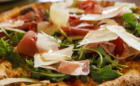 Artisan pizza with pancetta, shaved parmesan cheese and fresh arugulaの写真素材