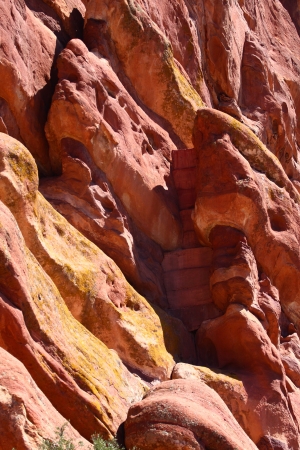 Vertical wall of red rock with many interesting formationsの写真素材