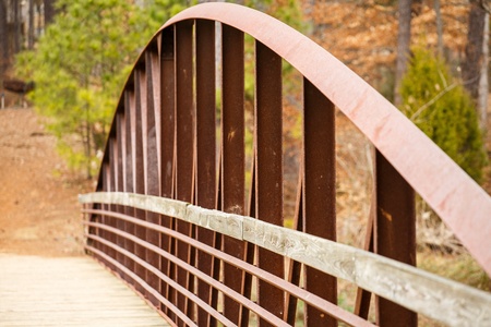 Old rusty steel and wood bridge in a forestの写真素材