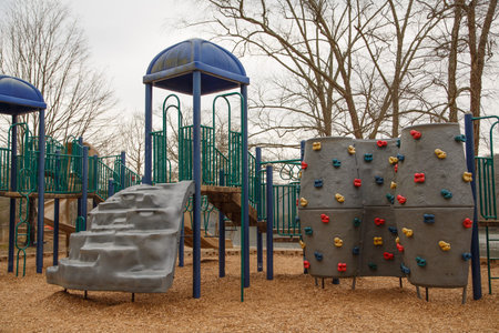 A children's playground with a climbing wall