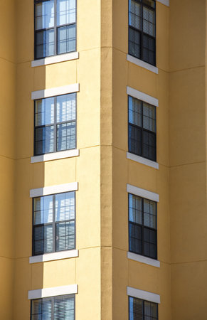 Windows in corner of a yellow stucco condo tower