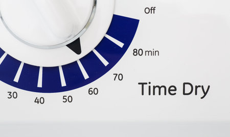 Blue and white timer on a dryer set to 60 minutes