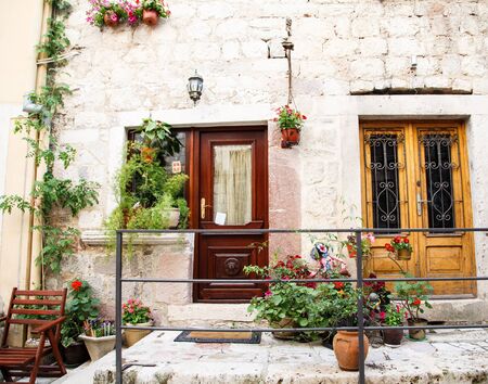 Flowers on an old stone porch in a home in the walled city of Kotor, Montenegroの写真素材
