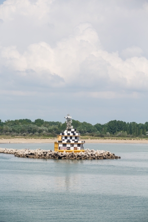 Black and white beacon at the entrance to the shipping channel into Venice, Italyの写真素材