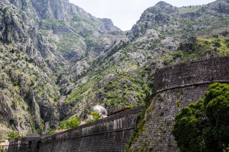 Old walls around Kotor beneath Montenegro mountainsの写真素材