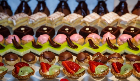 Rows of colorful desserts on a buffet tableの写真素材