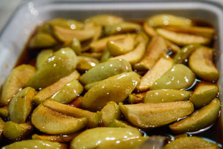 A pan of baked sliced apples in syrupの写真素材