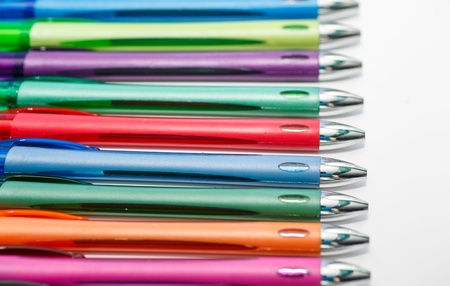 Line of many colored pens on a white backgroundの写真素材