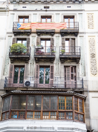 Banner with Spanish Flag colors over Apartment Windowsの写真素材