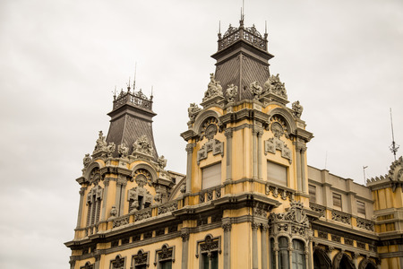 Roof and two towers at the top of an old Barcelona hotelの写真素材