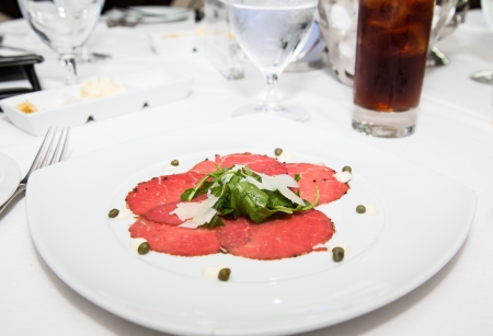 Appetizer of carpaccio, arugula and shaved parmesan cheeseの写真素材