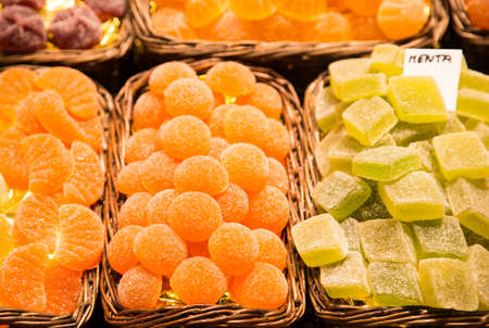Green and orange gummy candy at a marketの写真素材
