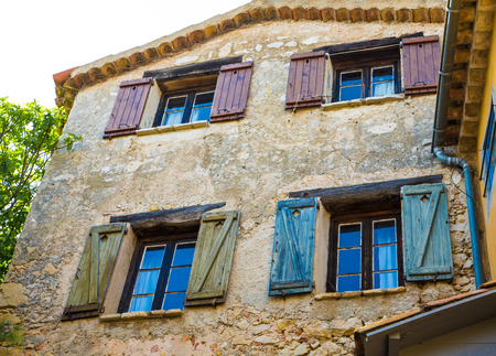 Colorful old wood shutters on a stone houseの写真素材