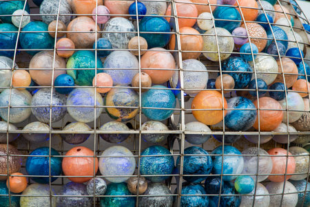 Many colored glass balls in a cage in Venice