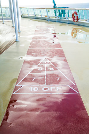 A shuffleboard court on the deck of a cruise ship after a rain