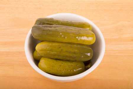A bowl of fresh, dill pickles in a bowl shot from aboveの写真素材