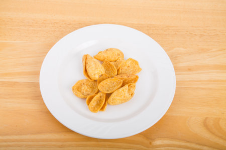 Fresh, tasty corn chips on a white plate
