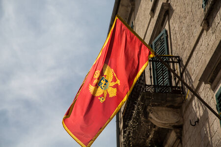 Red flag of Montenegro on an old building in Kotorの写真素材