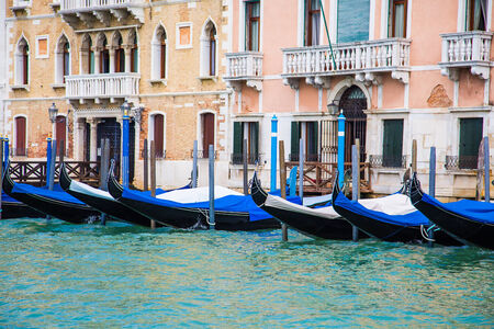 Old Venetian buildings with gondolas docked alongsideの写真素材