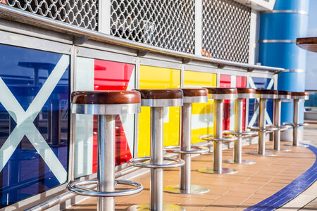 Wood and Steel Bar Stools on the deck of a luxury cruise shipの写真素材