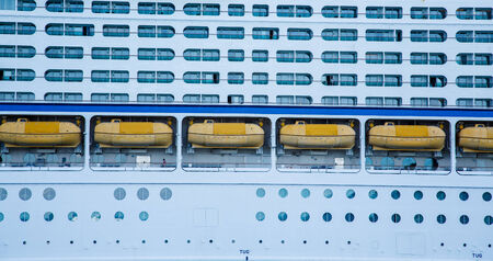 Huge, white, luxury cruise ship anchored in blue waterの写真素材