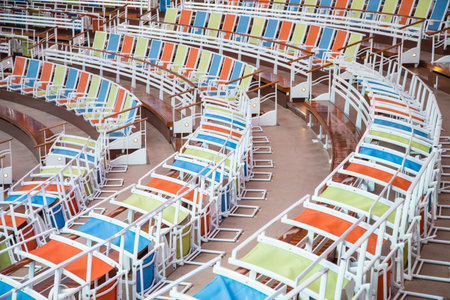 Curving rows of colorful chairs in an arena or stadium