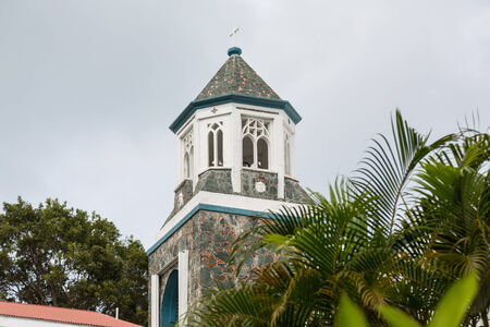 A wood and stone tower on an old church in the tropicsの写真素材