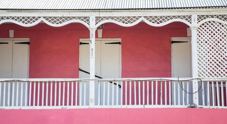 An old pink building with white trim on balconyの写真素材