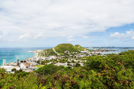 A view of bay on St Martin from hill with sugar factory on coastの写真素材