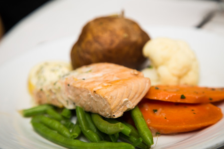 Poached salmon on plate with green beans, carrots, potato and cauliflowerの写真素材