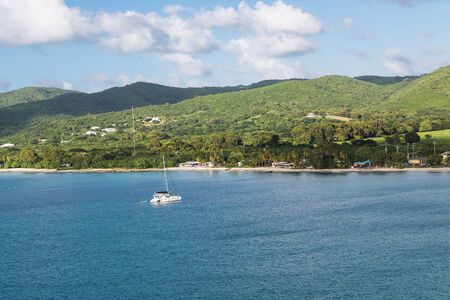 One white sailboat moored off the coast of St Croixの写真素材