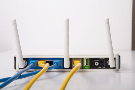 Modern wireless router with blue and yellow ethernet cables