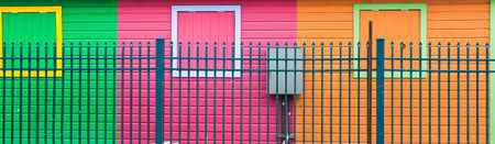 Bright colorful walls behind blue fence in Nassau, Bahamasの写真素材