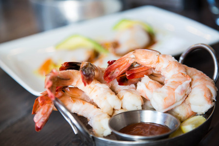 A serving of boiled shrimp with cocktail sauceの写真素材