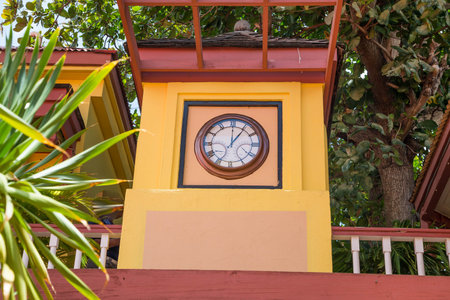 A colorful yellow clock tower on the Caribbean island of St Martinの写真素材