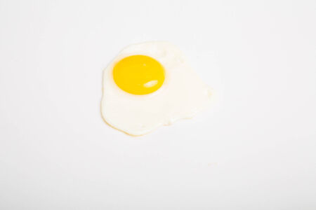 A fresh fried egg on a white backgroundの写真素材