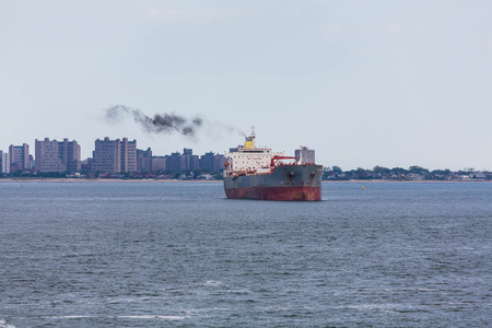 An old rusty tanker sailing off the coastの写真素材