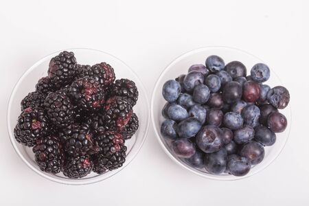 Fresh, ripe, juicy berries in clear cup on a white counterの写真素材