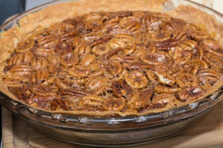 A whole freshly home made pecan pie ready to eatの写真素材