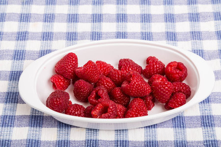 Bowl of fresh, ripe, red raspberries