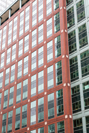 A classic red brick building by modern green glass in Chicago