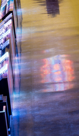 Light through stained glass windows onto church floor and pews