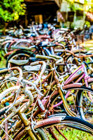 Many old rusty bikes at a scrapyardの写真素材