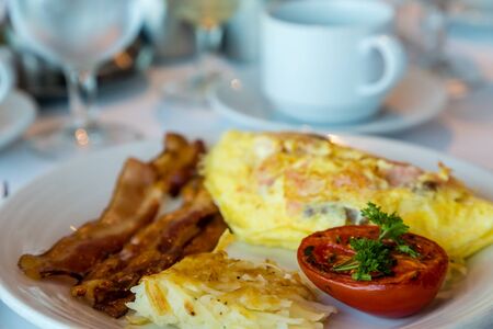 A fresh Omelet of smoked salmon and cheese with Bacon Hash Browns and Broiled Tomato.jpgの写真素材