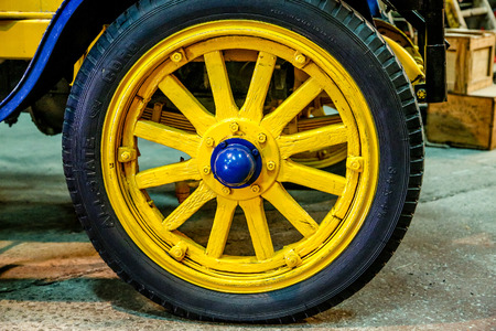 Brightly painted old wheel in blue and yellowの写真素材