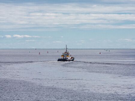 A tugboat heading out to sea from Saint John, New Brunswick, Canadaの写真素材